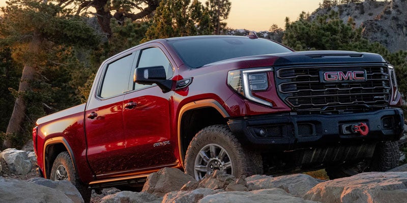 2026 GMC Sierra 1500 red pickup truck on rocky terrain