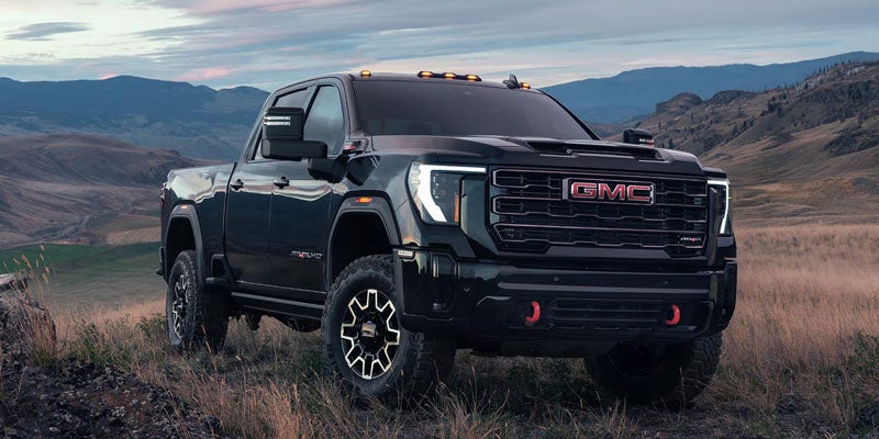 2026 GMC Sierra 2500 HD black truck in mountain terrain